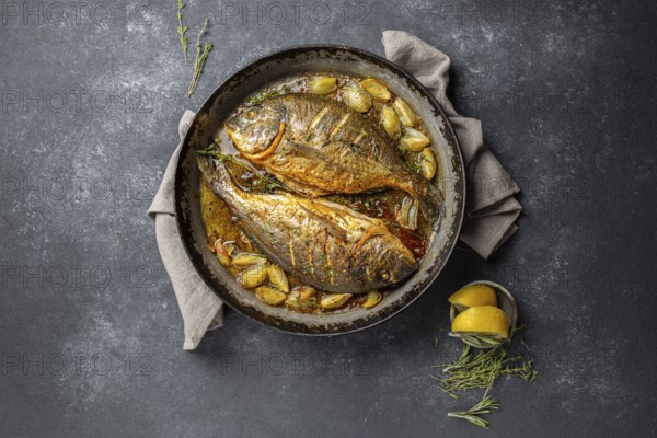 Food, Food, Baked sea bream or dorada with onion and herbs in pan on dark background