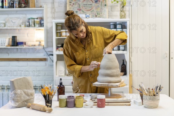 Talented ceramist crafting unique pieces in her studio