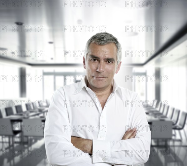 Senior expertise gray hair businessman posing interior white modern office