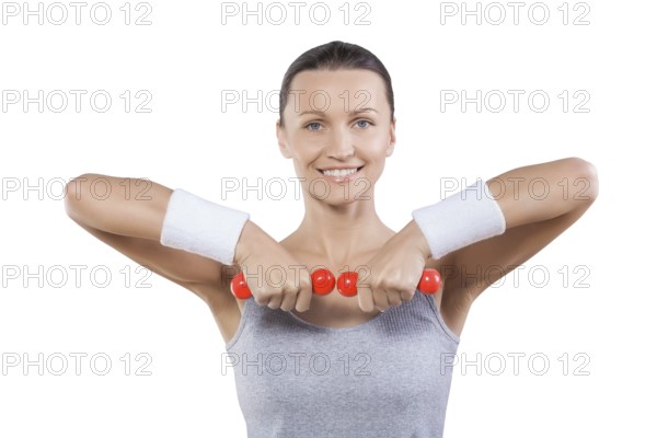 Close up portrait sport woman with little red dumbbells looking at camera smiling isolated