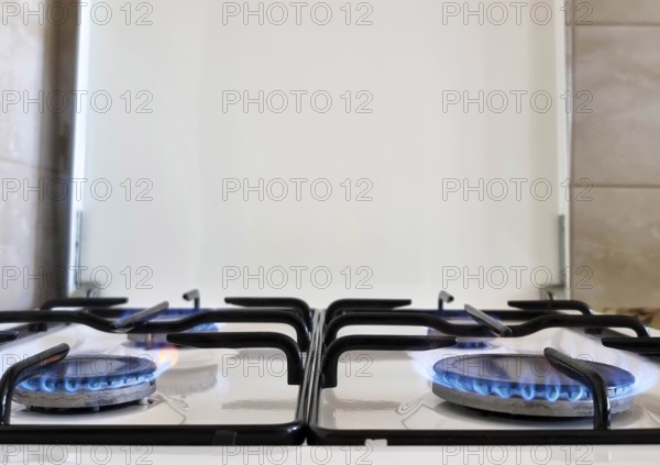 Energy efficiency concept with gas cooker – the cost of natural gas is more expensive. Close up, selective focus