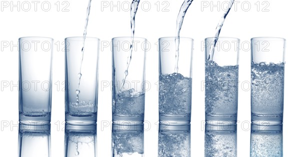 Pouring of fresh cool water in a glass isolated on white background