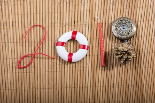Happy Year 2018 decoration with life preserver, coins, cone and watch