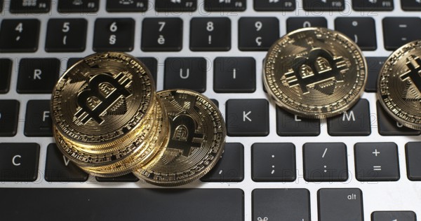 Bitcoins on Computer Keyboard Background