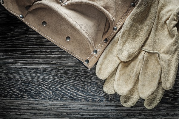 Protective gloves made of leather belt on black cardboard