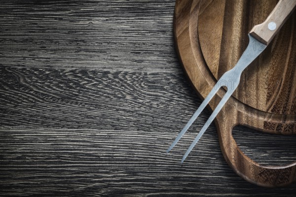 Meat fork Wooden cutting board on wooden background