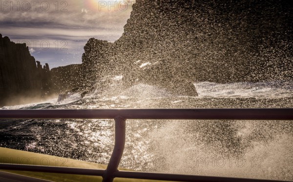 View from tour boat with handrail on Tasman Island, Tasmania, Australia, Oceania