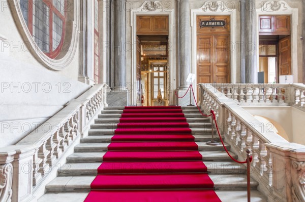 Turin, Italy - Circa January 2022: red carpet in Royal Palace - luxury elegant marble stairway