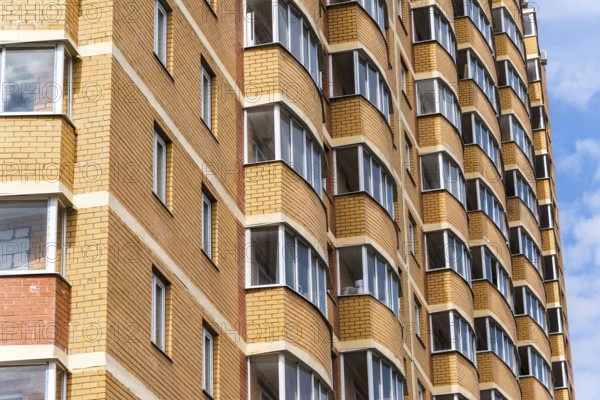 Modern high-rise apartment building made of a brick