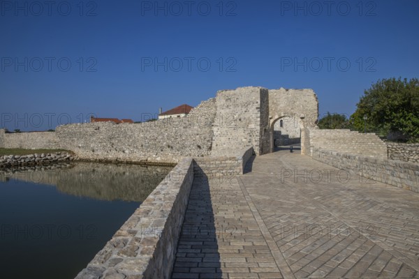 Skyline of a small Mediterranean town, historic city centre with massive city walls on an island in a bay or lagoon. Morning atmosphere in Nin, Zadar, Dalmatia, Croatia, Adriatic Sea, Europe