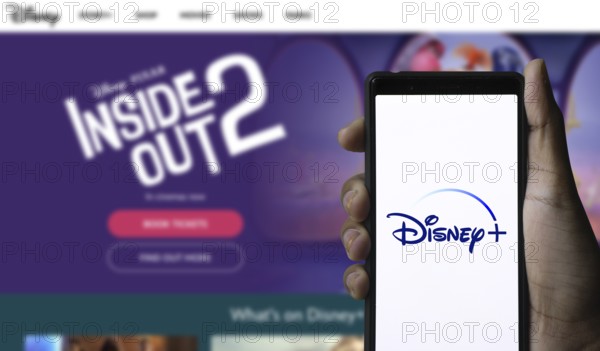 Smartphone with Disney+ logo displayed on the screen.