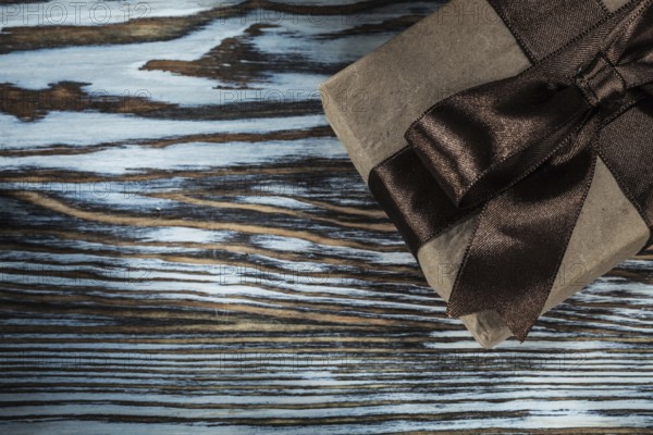 Packed brown gift box on wooden background