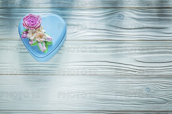 Present box on wooden board top view holidays concept
