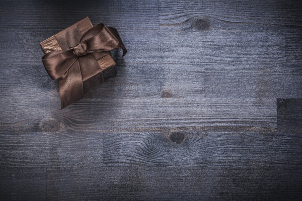 Packed gift box glittery paper on wood board holiday concept