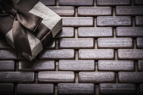 Packed giftbox on wooden wicker matting holidays concept