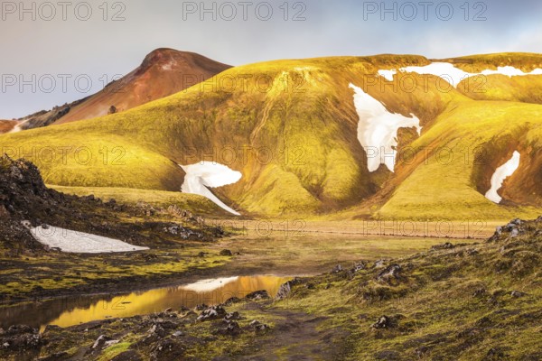 Magic sunrise in the Arctic. The golden light of dawn illuminates the mountains and glaciers national park Landmannalaugar, Iceland, Europe