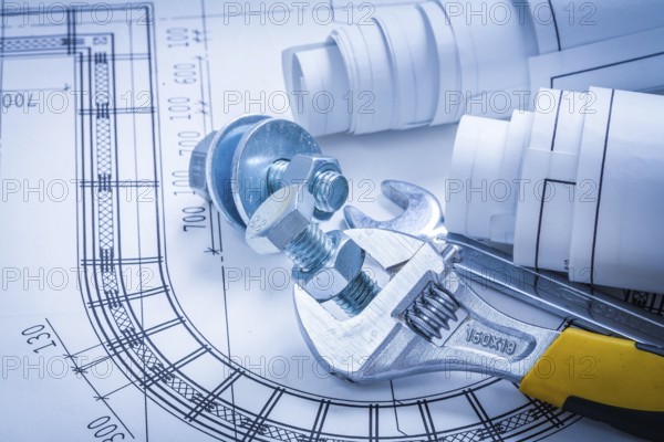 Adjustable key spanner bolts nuts and construction drawings maintenance concept