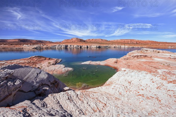 Lake Powell in the U.S. The coast is cut by narrow canyons. Grandiose huge lake of artificial origin among the picturesque red sandstone cliffs