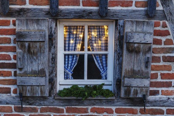 Rustic window with blue curtains and Christmas lights, weseke, borken, münsterland, North Rhine-Westphalia, germany