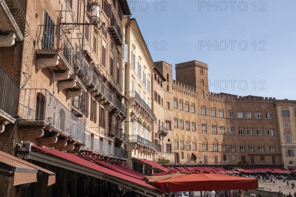 Old medieval brick houses surrounding the famous Piazza del Campo in the center of Siena, Italy, Europe