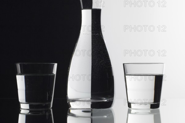 Glasses of water on the black and white background on the glass table