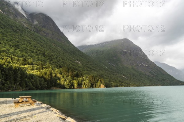 The Kjenndalsbreen is part of the Jostedalsbreen, one of the largest glaciers in Norway, and forms an impressive mountain landscape with a beautiful lake in Sande. The glacier Kjenndalsbreen with a lake in Norway is a beautiful place to travel to in summertime