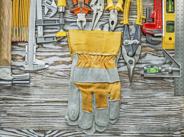 Heap of construction tooling on wooden board