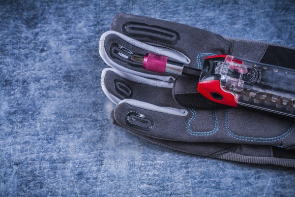 Muunction toolbox staff safety gloves on metallic background
