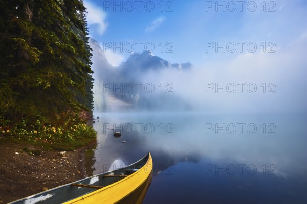 Fishing boats moored on the shore. Foggy morning on Emerald Lake. Canada, Yoho National Park