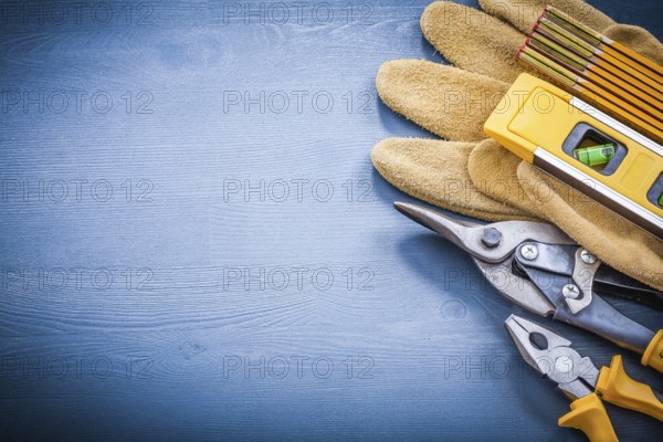 Pliers steel cutter wooden meter construction level protective gloves copyspace