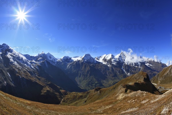 Austrian Alps. Great highway winds between hillsides yellowed. Excursion to the picturesque panoramic way Grossgloknershtrasse. Sunny day in early autumn