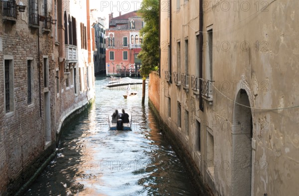 Man on a boat in Venice. Pass thru the channel