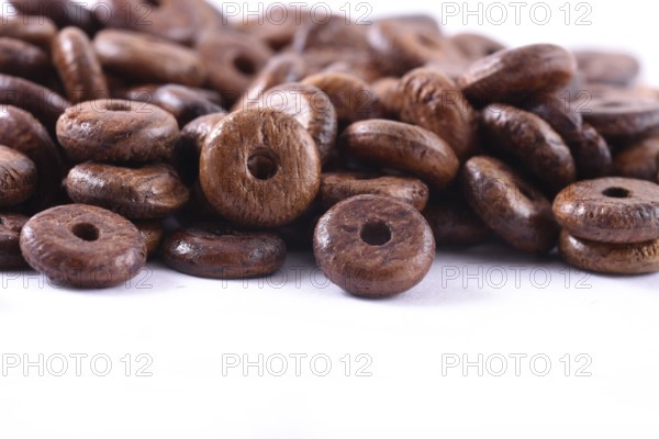 Wooden beads close-up on white background. Close up, macro