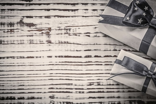 Wrapped gift containers on vintage wooden board copyspace holidays concept