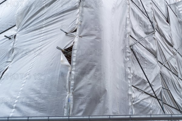 Building covered with a tarpaulin