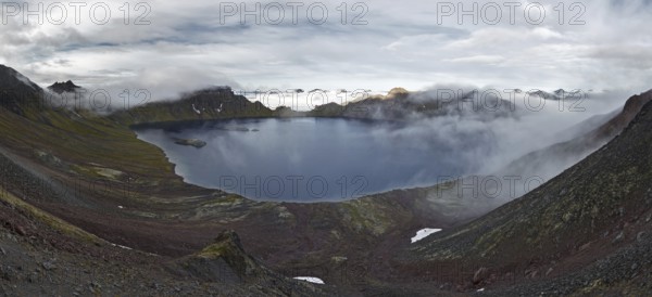 Scenery panorama landscape of Kamchatka Peninsula: view of beautiful mountain lake in crater active Khangar Volcano and islands in lake. Eurasia, Russian Far East, Kamchatka Region