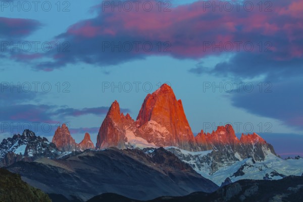 Amazing Patagonia in February. Sharp tops fantastically beautiful cliffs Fitz Roy crimson light rays of sunset