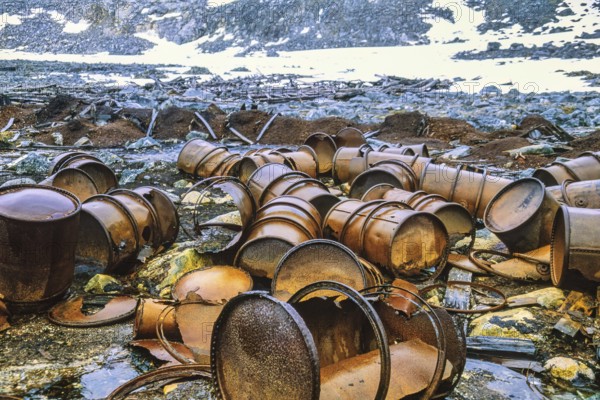 Rusty barrels after polar expeditions on Svalbard