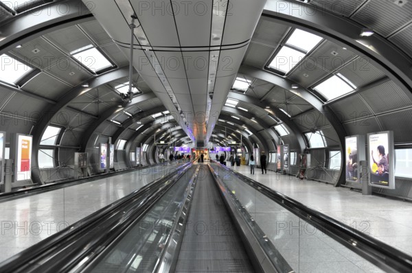 Frankfurt Airport, Frankfurt am Main, Hesse, Germany, Europe, Futuristic airport tunnel with escalators, illuminated and with some passengers in the background, Yucatán region, Mexico, Central America, Europe