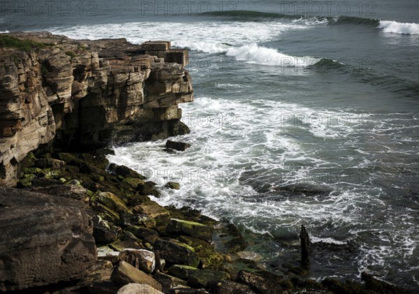 The rocky coastline along the shore of North Sea in Northumberland County, England, United Kingdom, Europe