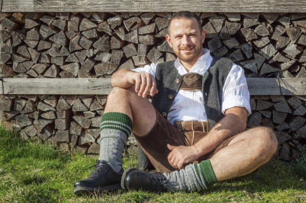 An image of a traditional bavarian man is taking a rest