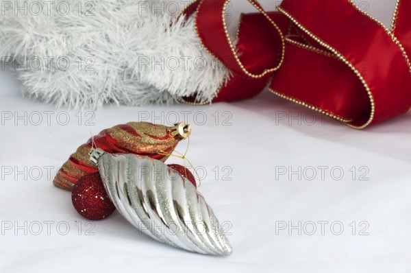 Christmas motifs with balls and chains. Red and white balls, white chains and red ribbon