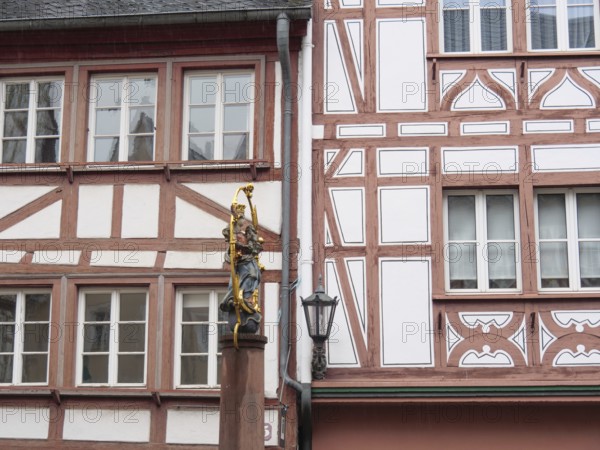 Half-timbered wall with statue of the Virgin Mary standing next to a street lamp post, mainz, rhineland-palatinate, Germany, Europe