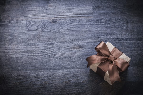 Packed gift box-container on vintage wood board holiday concept