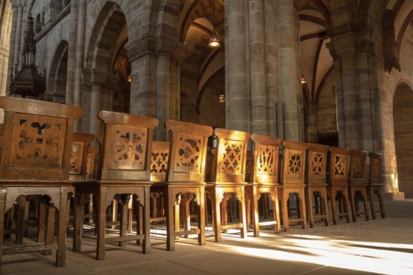 An image of a row of wooden chairs in an old church