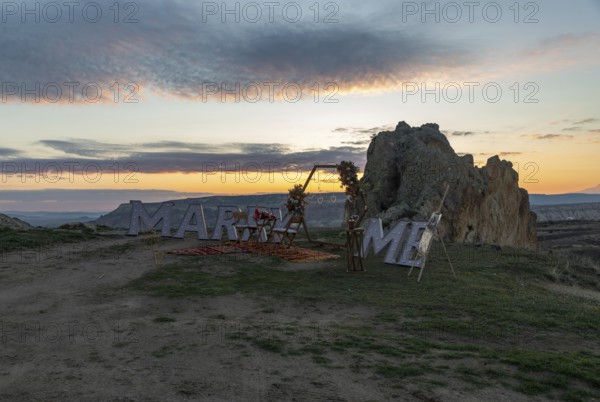 A picture of the Marry Me sign atop Love Valley, part of the Goreme Historical National Park, at sunrise