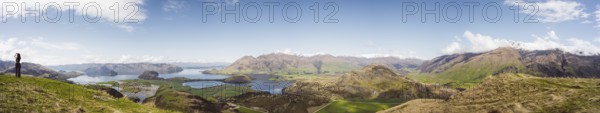 View over a wide mountain landscape with lakes and green terrain under a clear sky, Wanaka, New Zealand, Oceania
