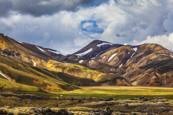 Valley National Park Landmannalaugar. On the gentle slopes of the mountains are snow fields and glaciers. Magnificent Iceland in the summer