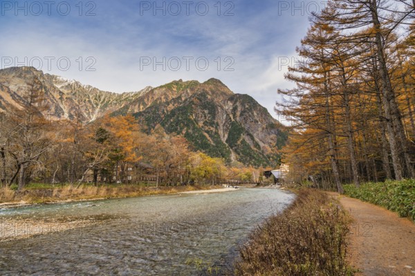 Nature landscape at Kamikochi Japan, autumn foliage season with pond and mountain