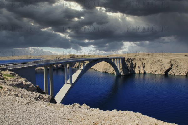 Impressive bridge spans a river under a dramatic, cloudy sky, Pag Bridge, Pag, Dalmatia, Croatia, Europe